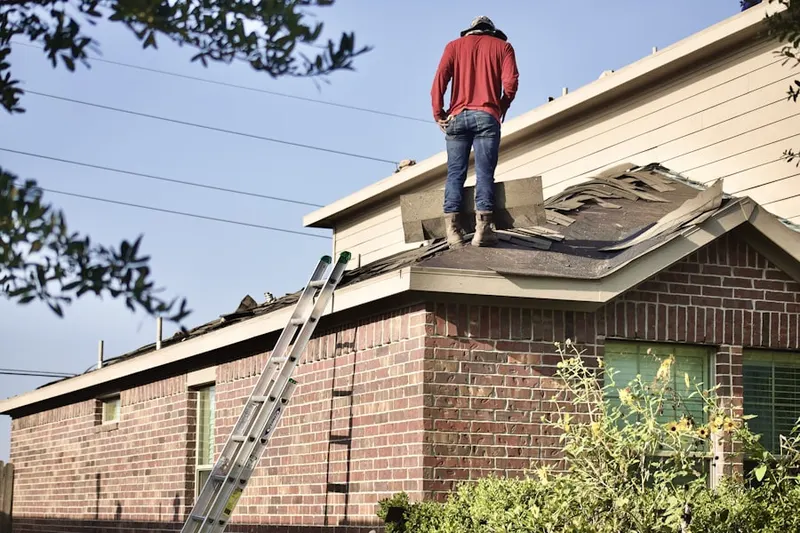 Professional roofer working on a residential roof in Mill Creek East